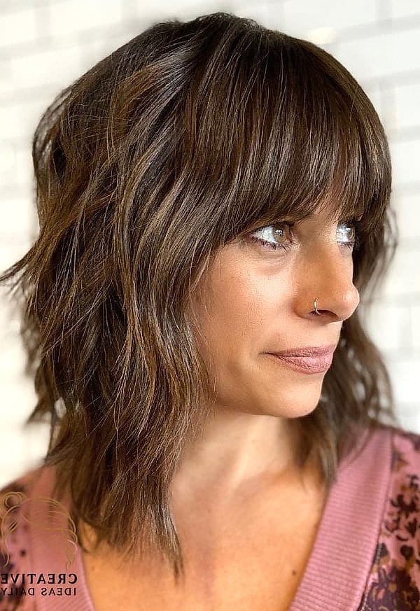 27 Medium Length Hair Ideas Every Woman Needs to See 2 Layered Shag With Wispy Bangs
